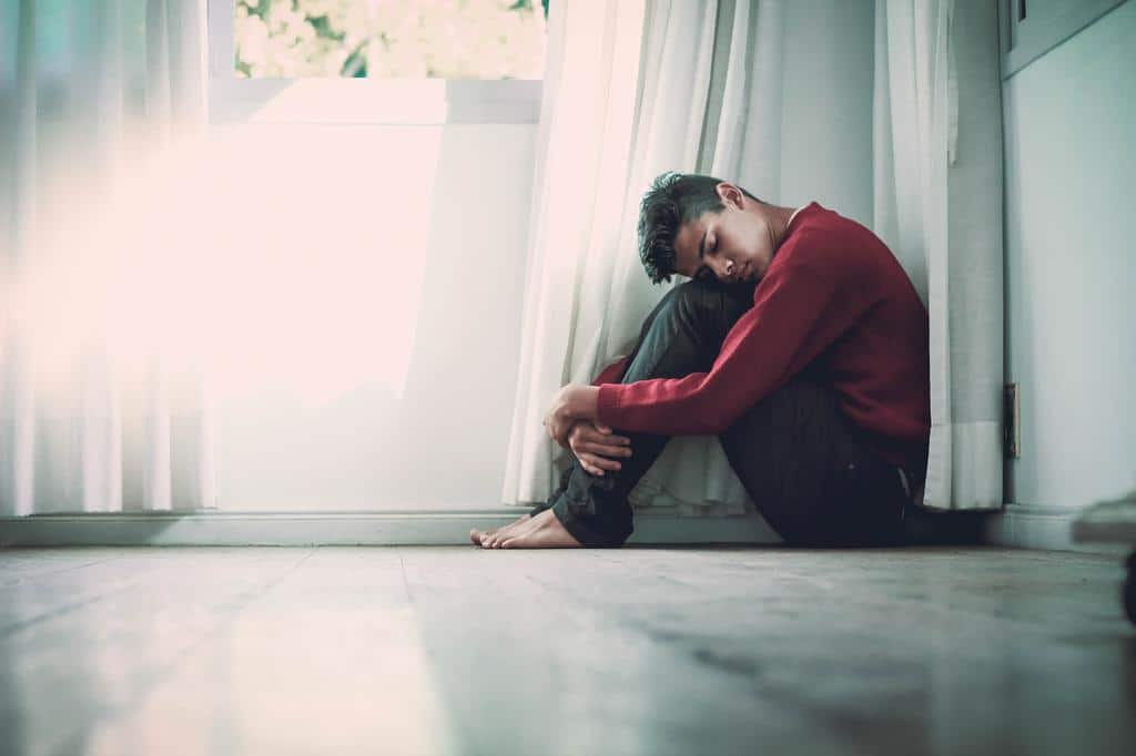 young man sitting in room on floor
