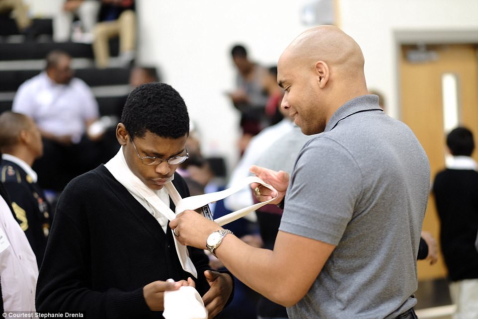 Meanwhile, mentors and fathers handed out ties to the students and helped them 'perfect their half-Windsor knot,' according to Drenka