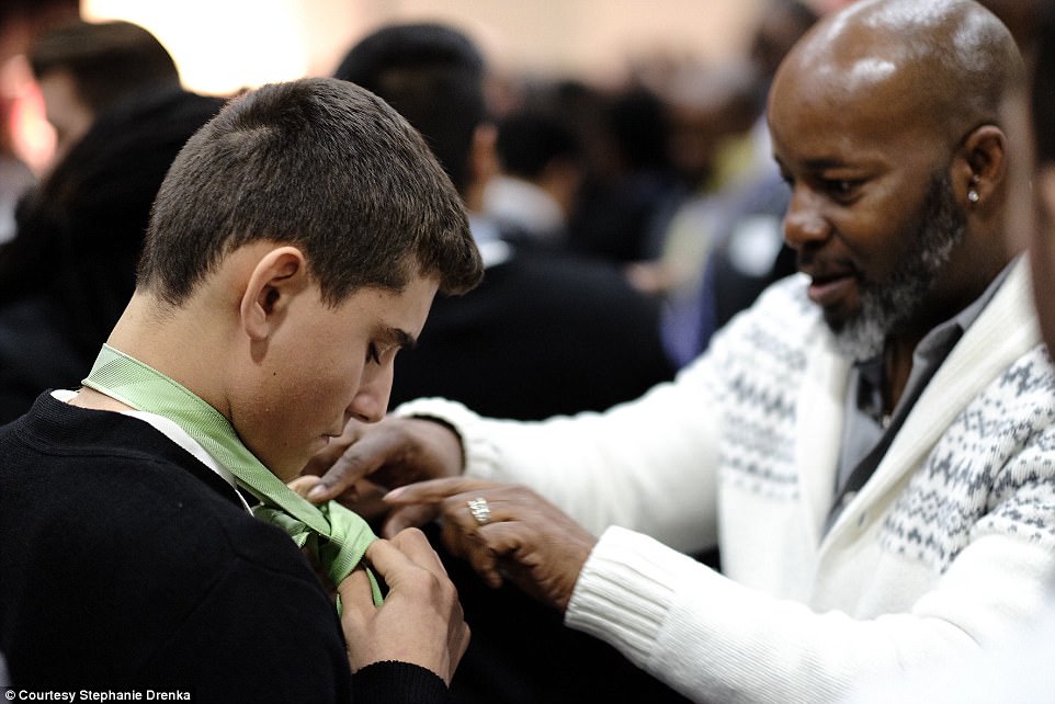 According to Drenka, Jamil 'The Tie Man' Tucker led the auditorium in a hands-on icebreaker activity. Pictured is one of the mentors helping a student tie his necktie 