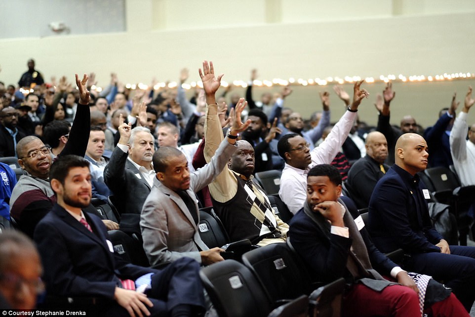 This heartwarming act of kindness occurred last month at Billy Earl Dade Middle School in Dallas. Pictured are some of the hundreds of father figures and mentors who showed up to the event 
